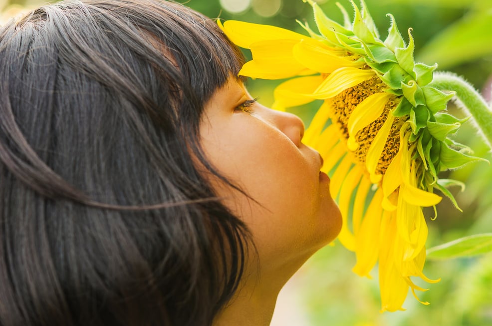 children with sunflower in nature